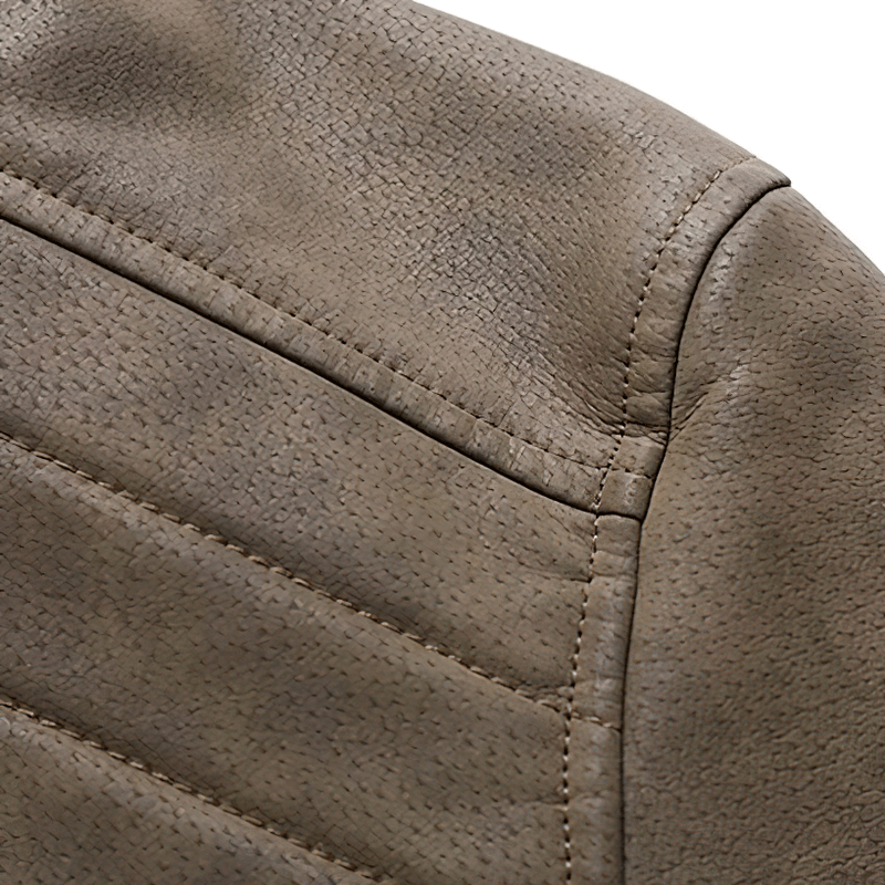 Detail of casual men's faux leather jacket showing textured fabric and stitching for a stylish look.