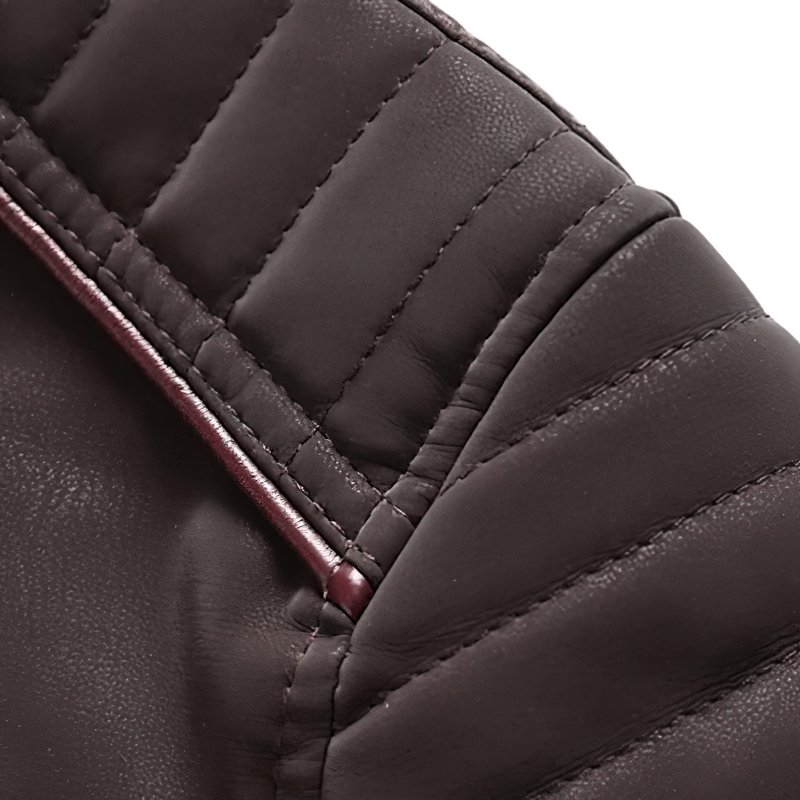 Close-up of the quilted detail on a brown PU leather motorcycle jacket's collar.