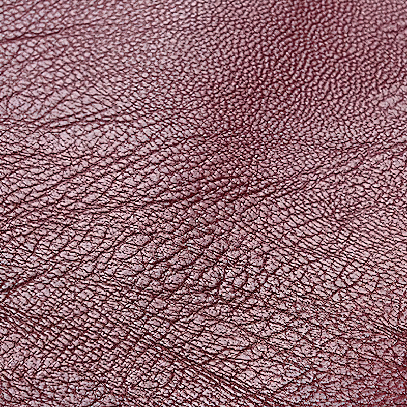 Close-up of rich, textured PU leather in a soft burgundy shade, perfect for stylish bags and accessories.