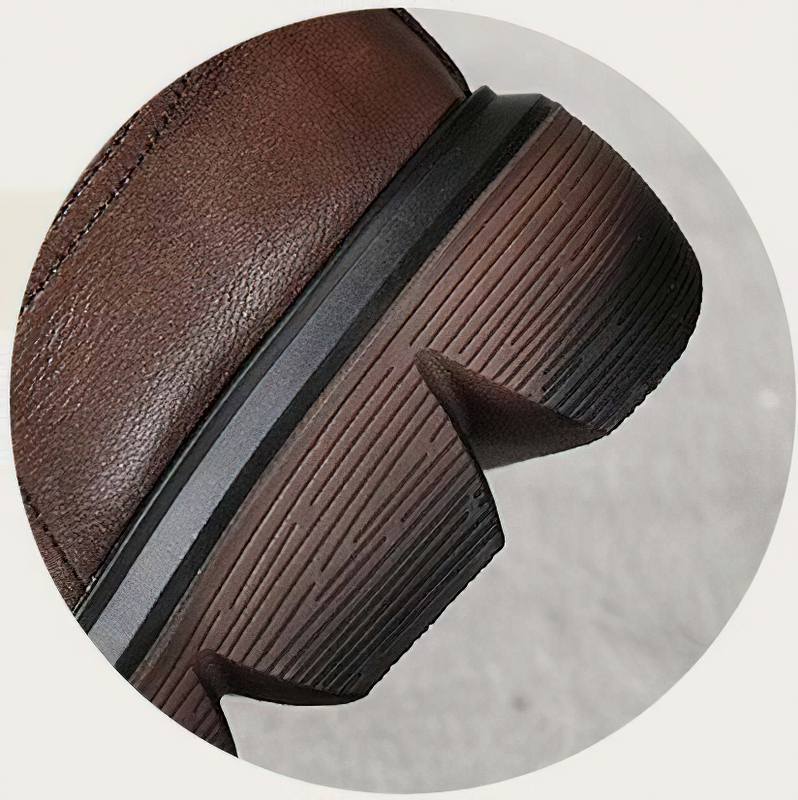 Close-up of the thick rubber sole of stylish brown women's leather boots for comfort and durability.
