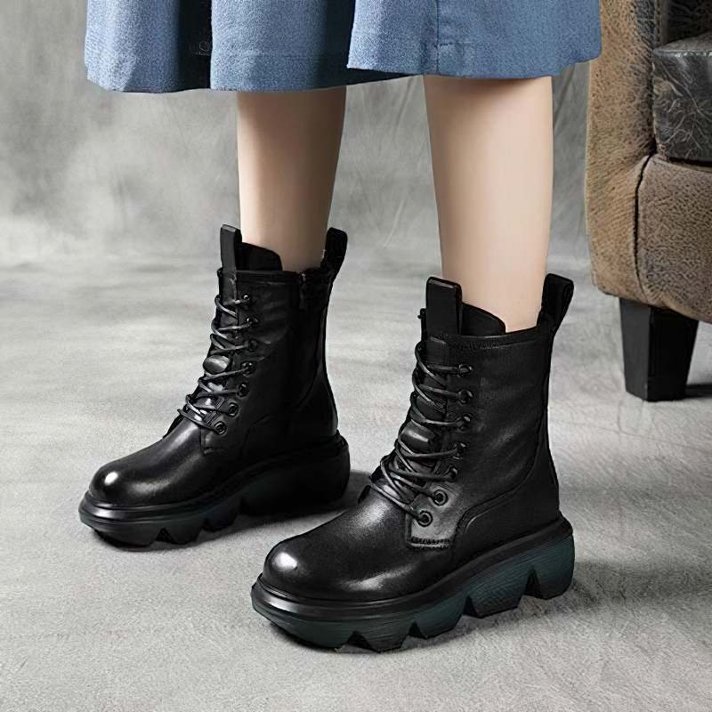 Stylish women's black leather boots with thick soles and laces, perfect for casual wear and comfort.