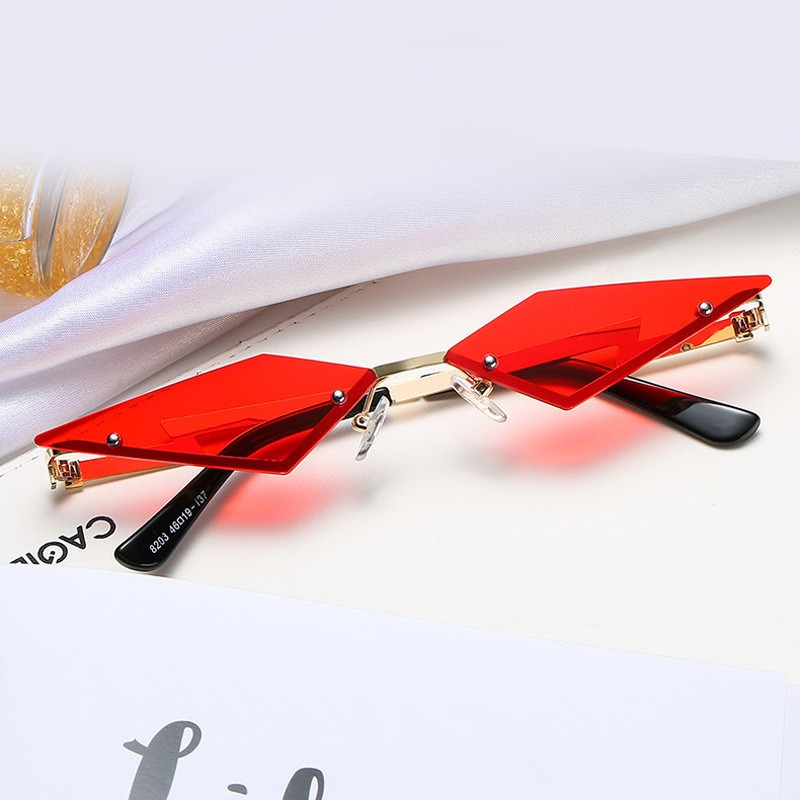 Stylish red cat eye sunglasses for men and women, showcasing a unique rimless design in a punk aesthetic.