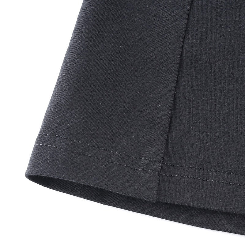Close-up of the fabric hem of a black dress showcasing high-quality stitching and elegant texture.