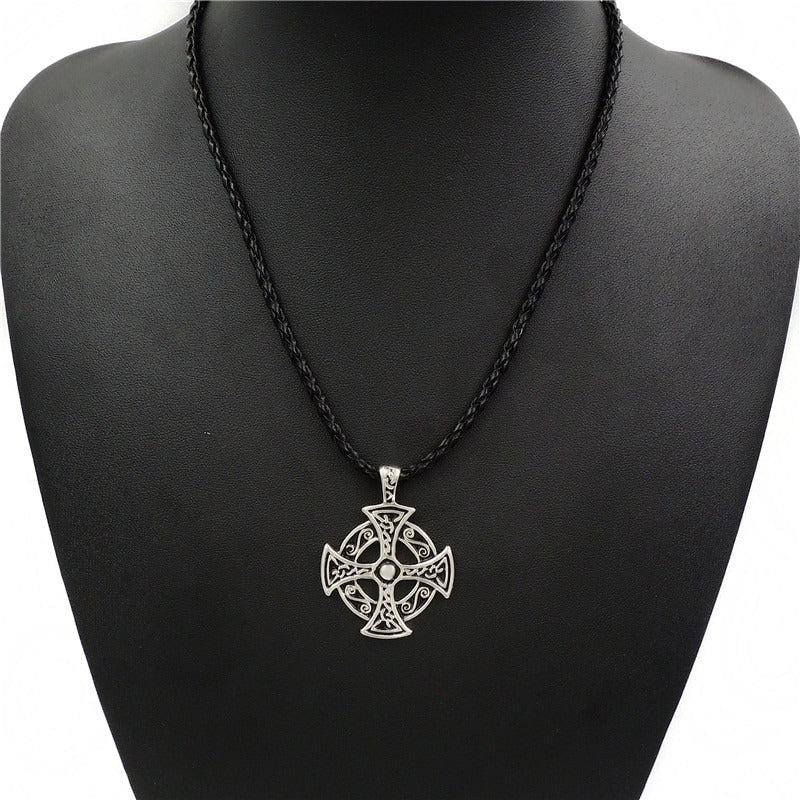 Celtic solar cross pendant necklace in zinc pewter showcasing a stylish design on a black braided cord.