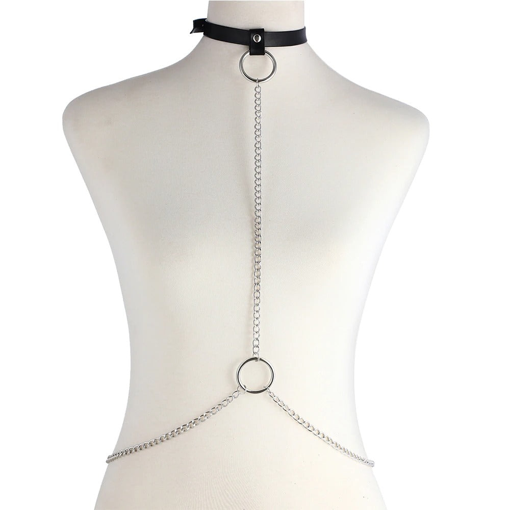 Gothic style chain body harness on a mannequin with imitation leather choker and decorative rings.
