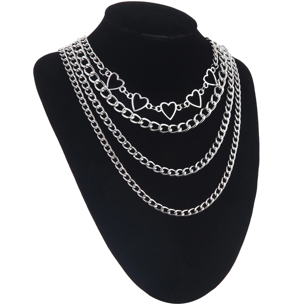 Layered chain necklace with heart details, perfect for a trendy fashion aesthetic for women.