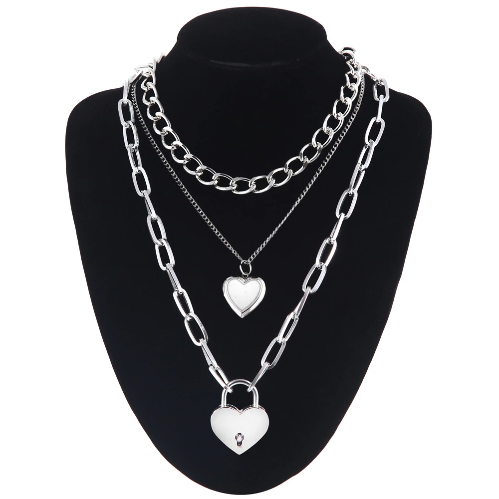 Layered chain necklace with heart and lock pendants, perfect for trendy fashion and versatile outfits.