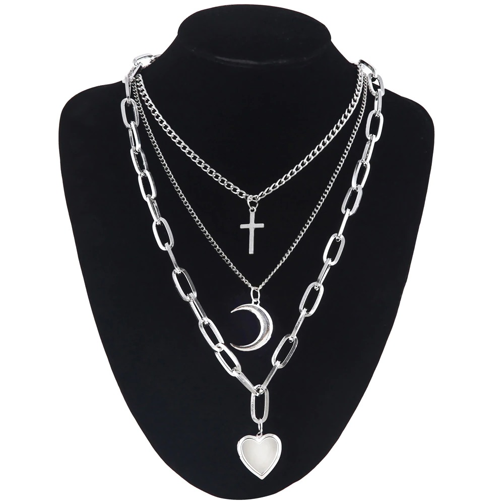 Trendy layered chain necklace for women featuring hearts, crescent moon, and cross charms, perfect for a stylish outfit.