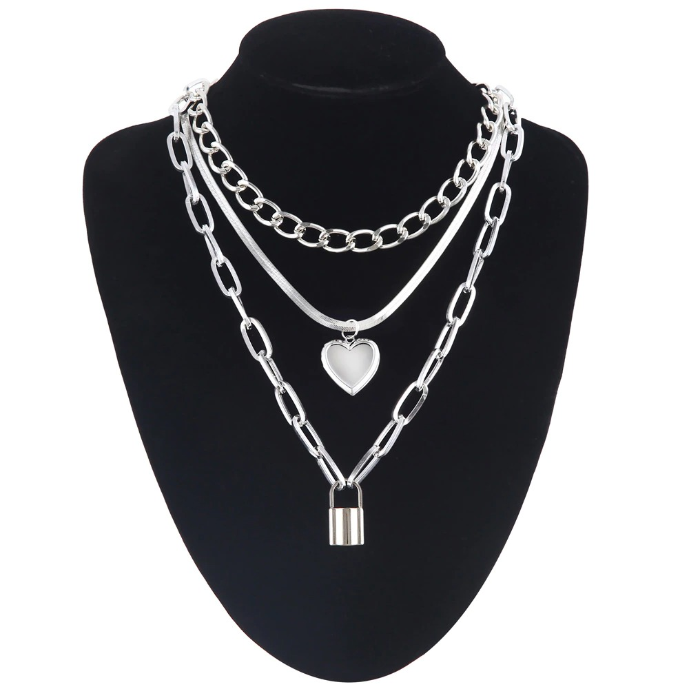 Layered chain necklace with heart pendant and lock charm, perfect for trendy women's fashion.