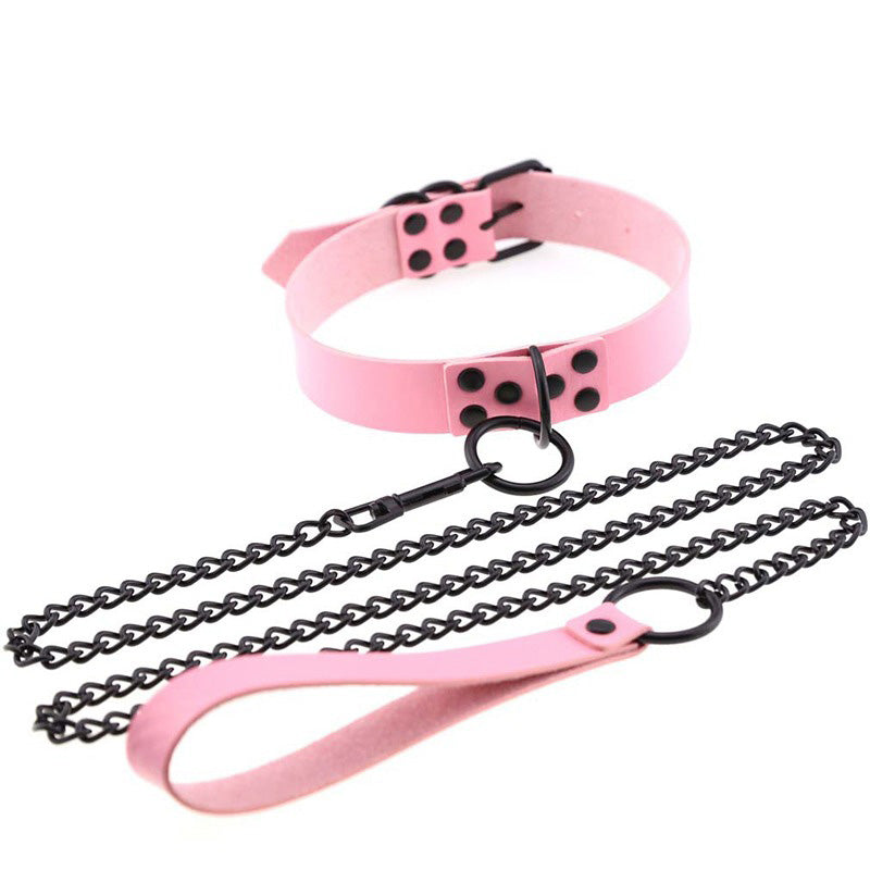 Pink faux leather choker with black chain and adjustable design for unisex bondage style.