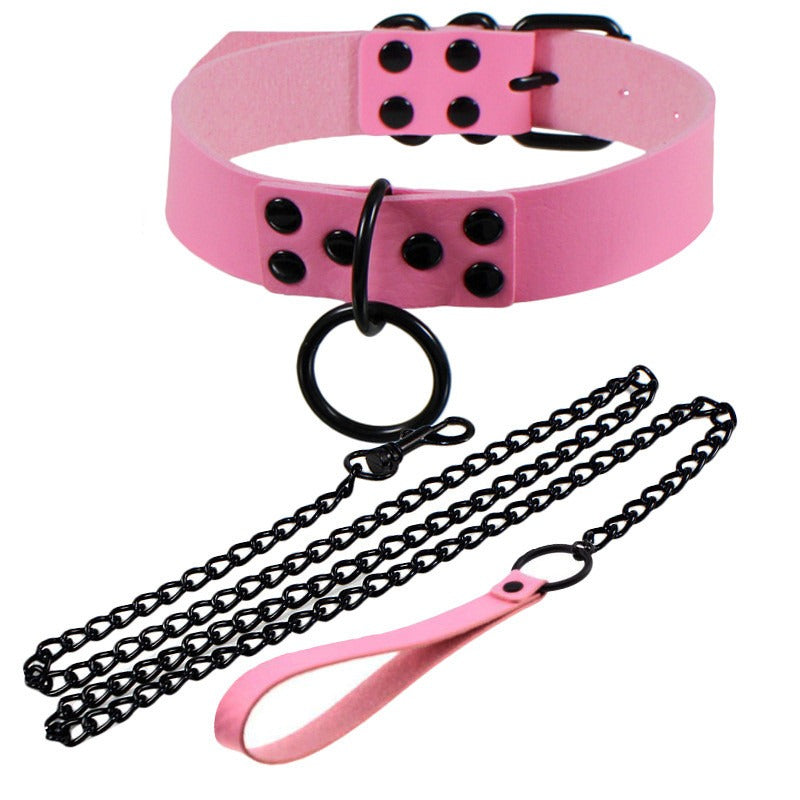 Pink faux leather choker with black chains and adjustable buckle, perfect for gothic and bondage-themed outfits.