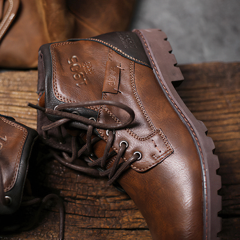 Classic brown ankle boots for men crafted from genuine leather, featuring waterproof design and sturdy lace-up closure.