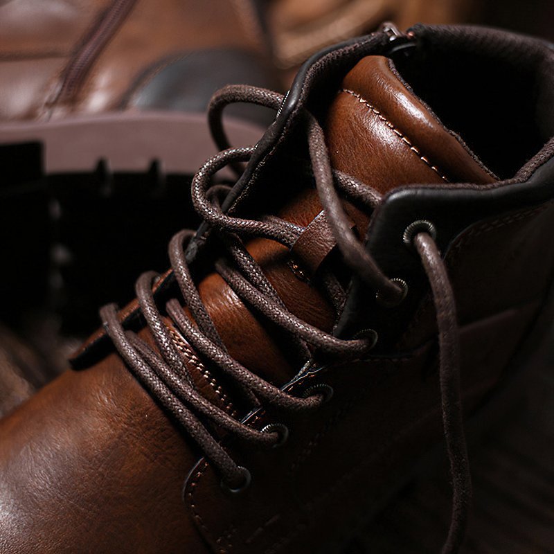 Close-up of stylish brown leather ankle boots with lace-up design, showcasing quality craftsmanship.