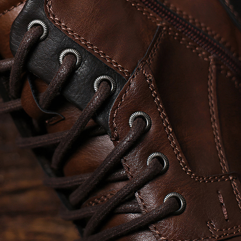 Close-up of brown leather ankle boots showcasing stylish laces and quality craftsmanship for men's casual wear.