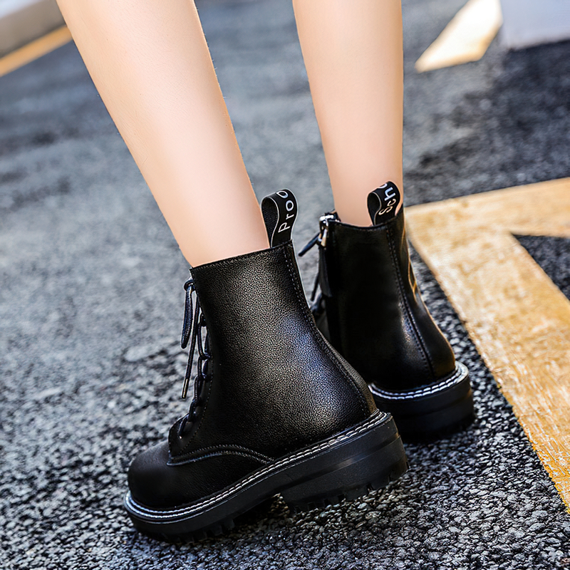 Classic British style women's black ankle boots featuring lace-up design and sturdy rubber sole for comfort.