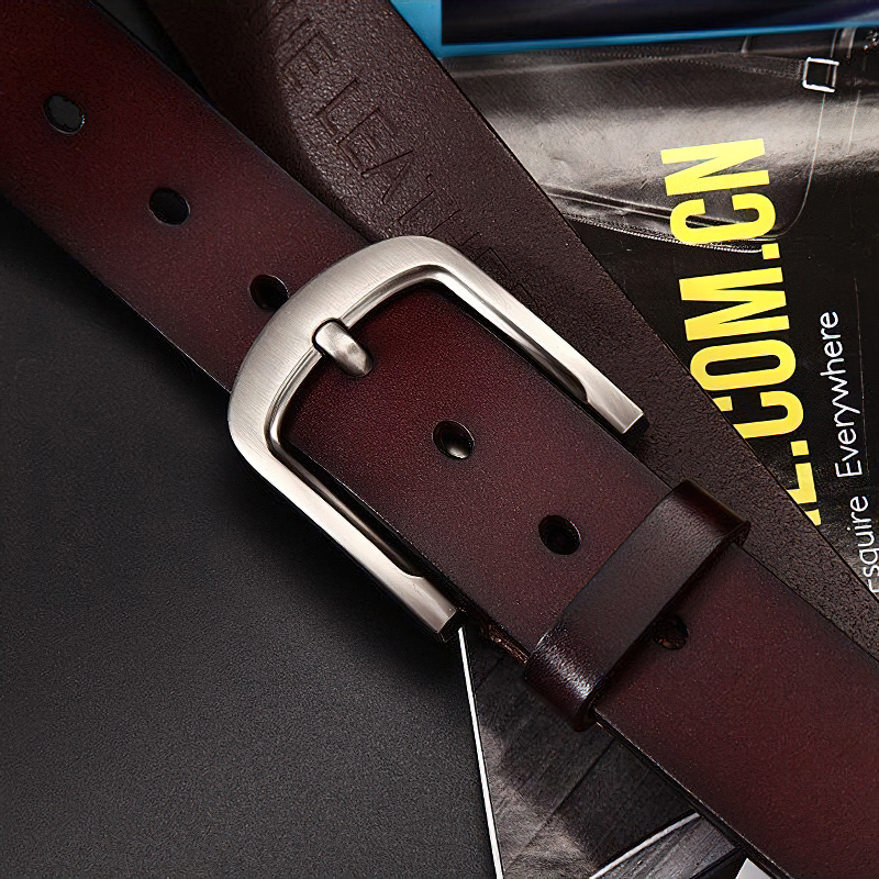Close-up of a classic genuine leather belt for men featuring a stylish metal buckle and rich burgundy color.