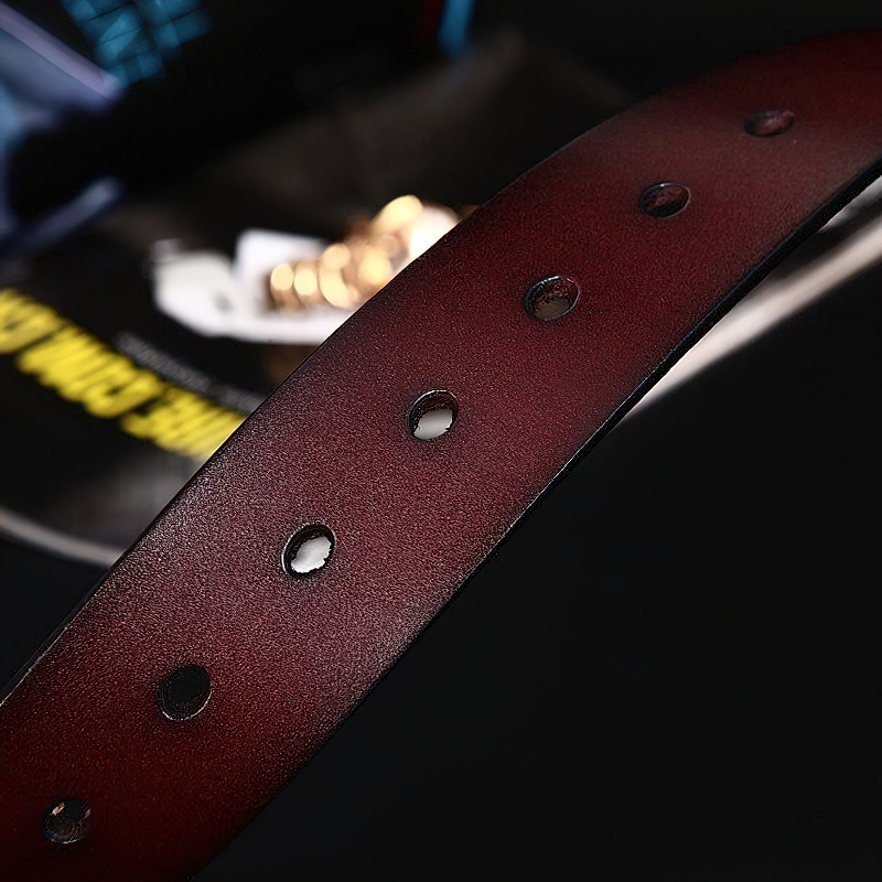 Close-up of a classic genuine leather belt showcasing holes, perfect for casual styles and denim outfits.