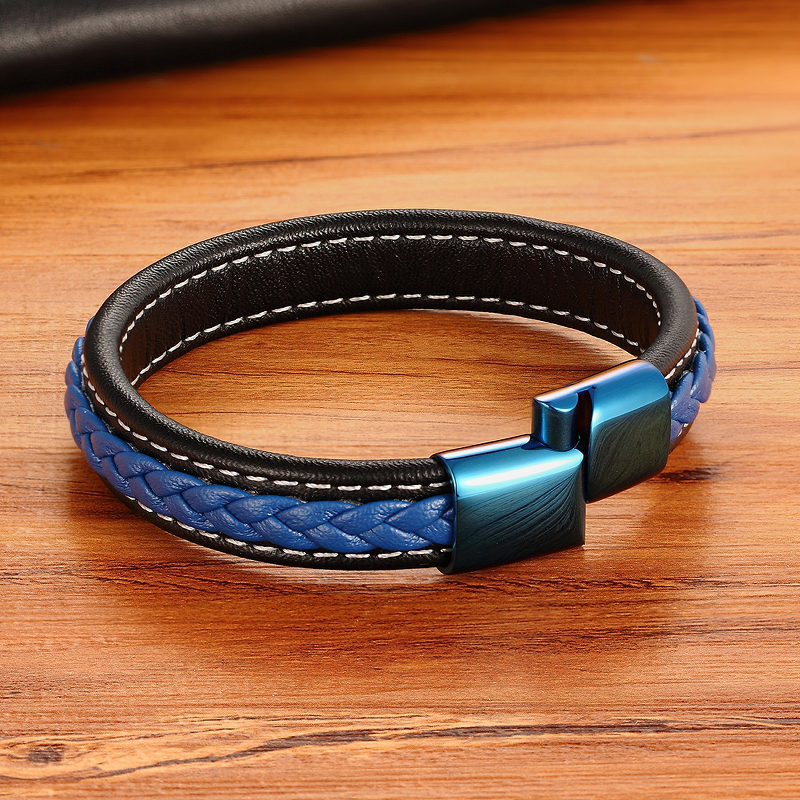Classic luxury blue braided leather bracelet with stainless steel buckle on a wooden surface.