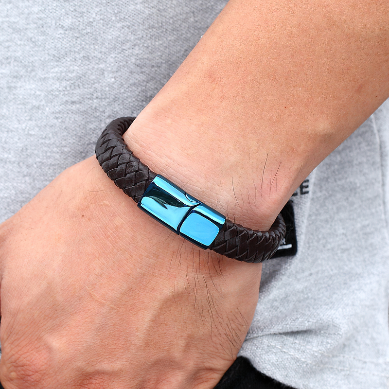 Braided leather bracelet with blue stainless steel buckle on a wrist, perfect for trendy fashion lovers.