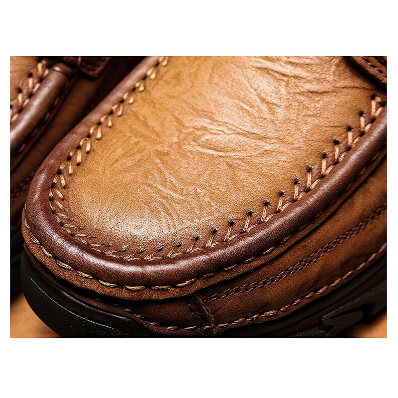 Close-up of classic men's genuine leather lace-up shoes showcasing detailed stitching and textured finish in alternative style.