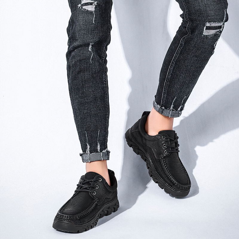 Classic black lace-up leather shoes for men, paired with ripped jeans, showcasing an alternative style.