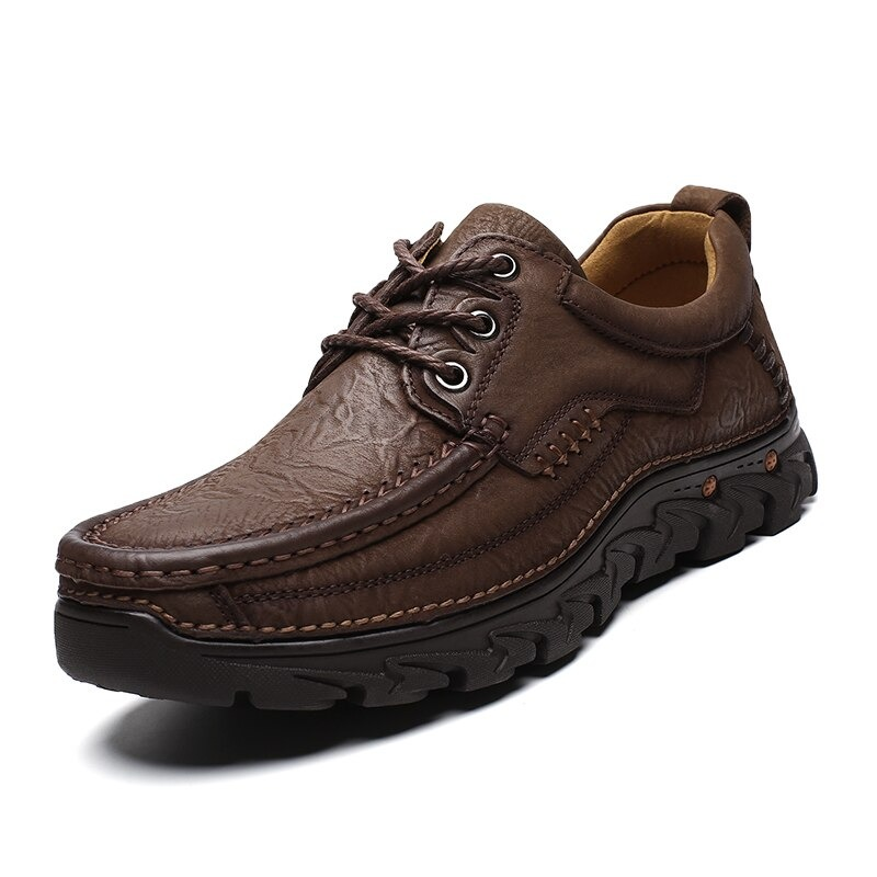 Classic men's brown leather lace-up shoe with textured design, perfect for alternative style and formal occasions.