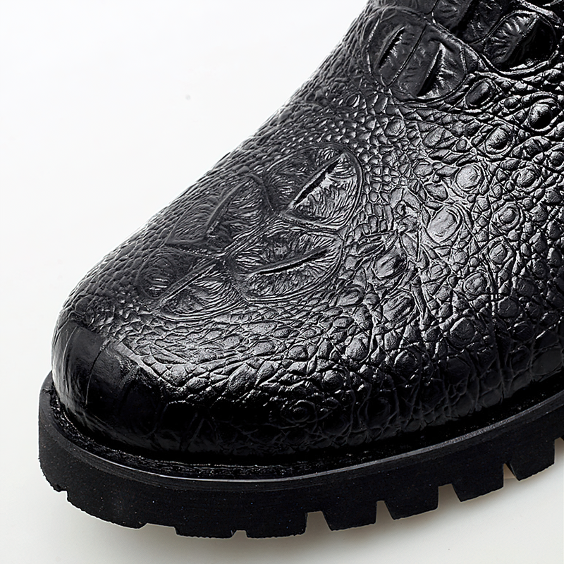 Close-up of stylish black PU leather ankle boot featuring a textured design and rugged sole.