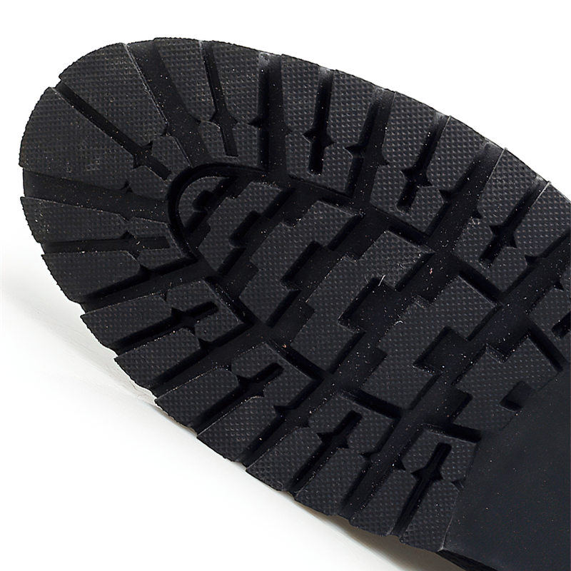 Close-up of the durable tread on a classic men's ankle boot sole for optimal grip and comfort.