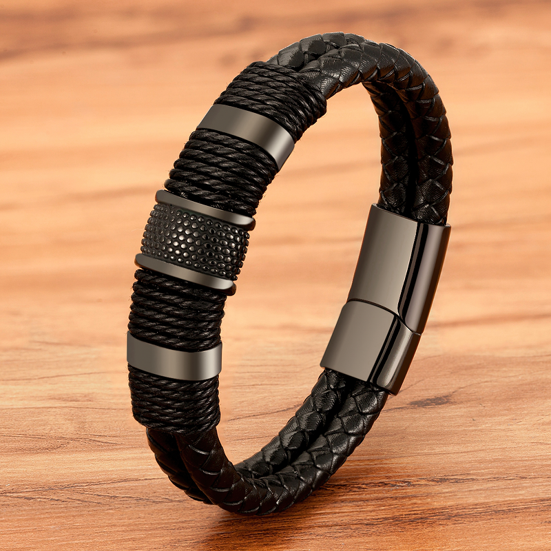 Classic black stainless steel men's leather bracelet with double-layer design on wooden background.