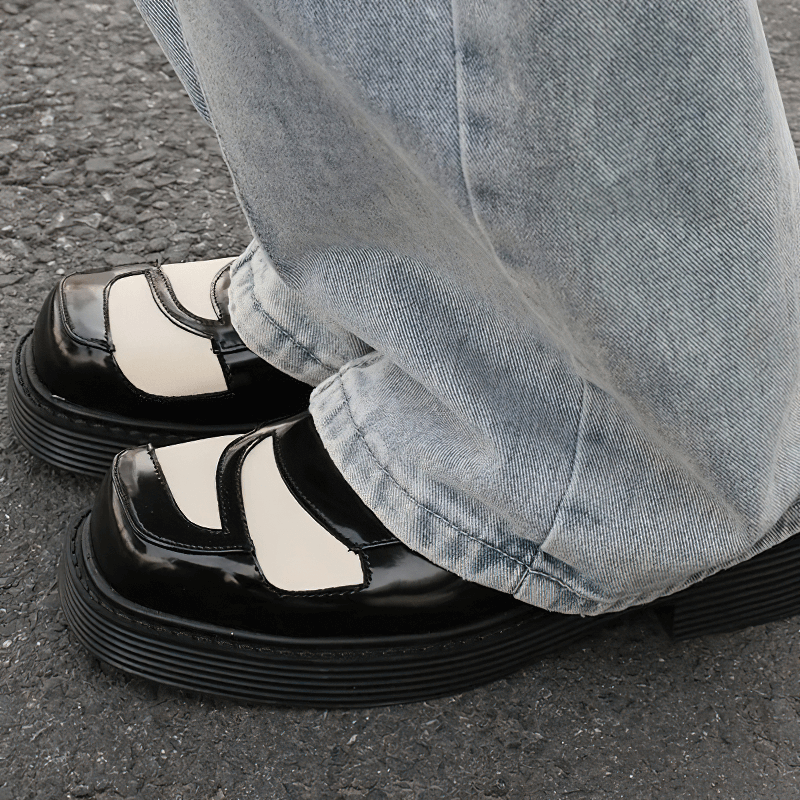 Men's black and white square toe derby shoes styled with casual jeans, showcasing retro elegance and comfort.