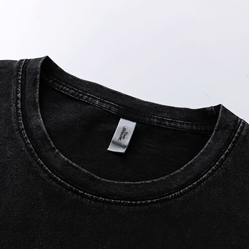 Close-up of the neckline of a black cotton t-shirt, highlighting the casual style and illusion letter print.