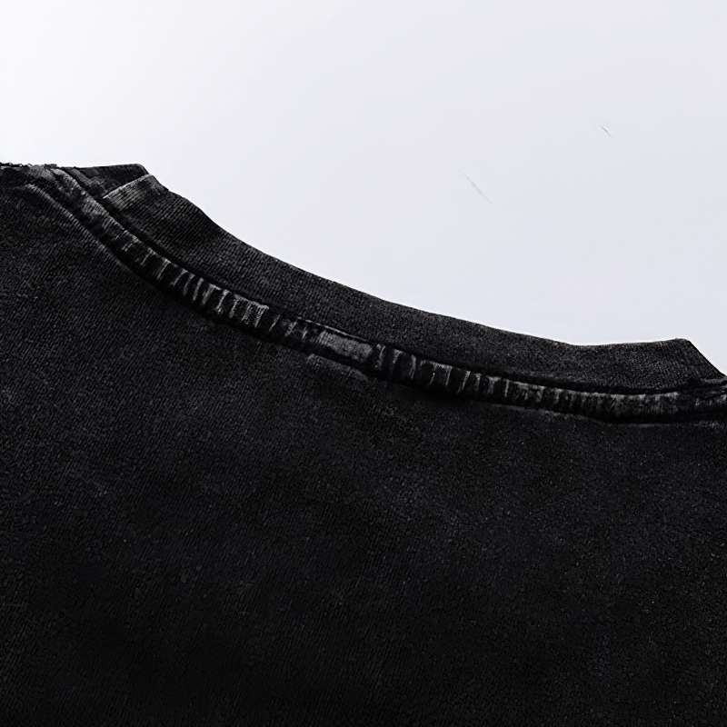 Close-up view of the neckline of the black illusion letter printed cotton t-shirt, showcasing its modern cut and soft fabric.