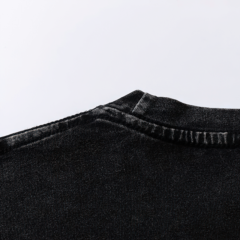Close-up of the neckline of a black cotton t-shirt highlighting its casual style and stitching details.
