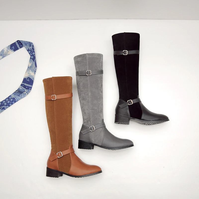Stylish ladies knee high boots in brown, gray, and black colors with low heels and buckle detail.