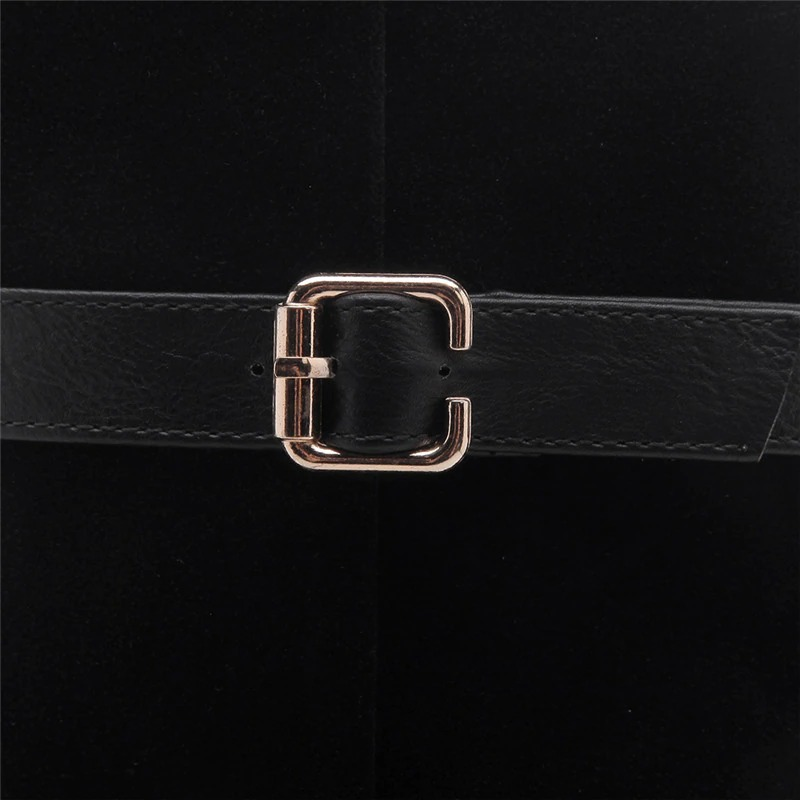 Close-up of women's knee-high boots featuring a stylish black buckle and leather details.