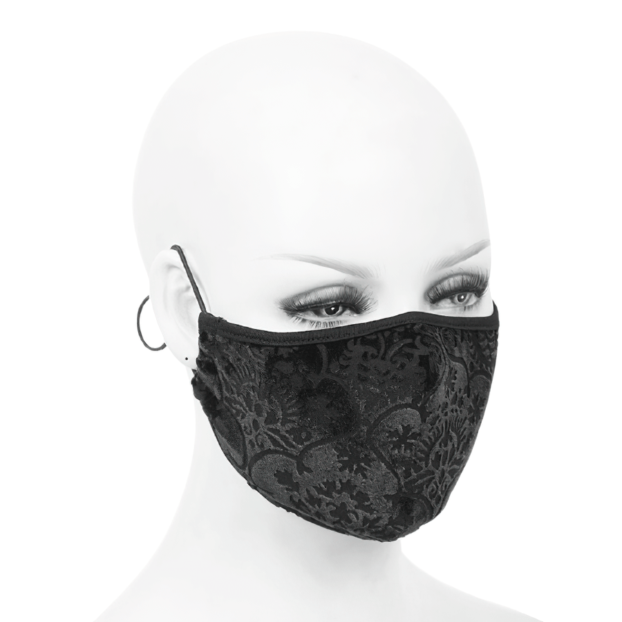 Elegant black mask with baroque patterns on a mannequin, showcasing gothic style and adjustable elastic cord.