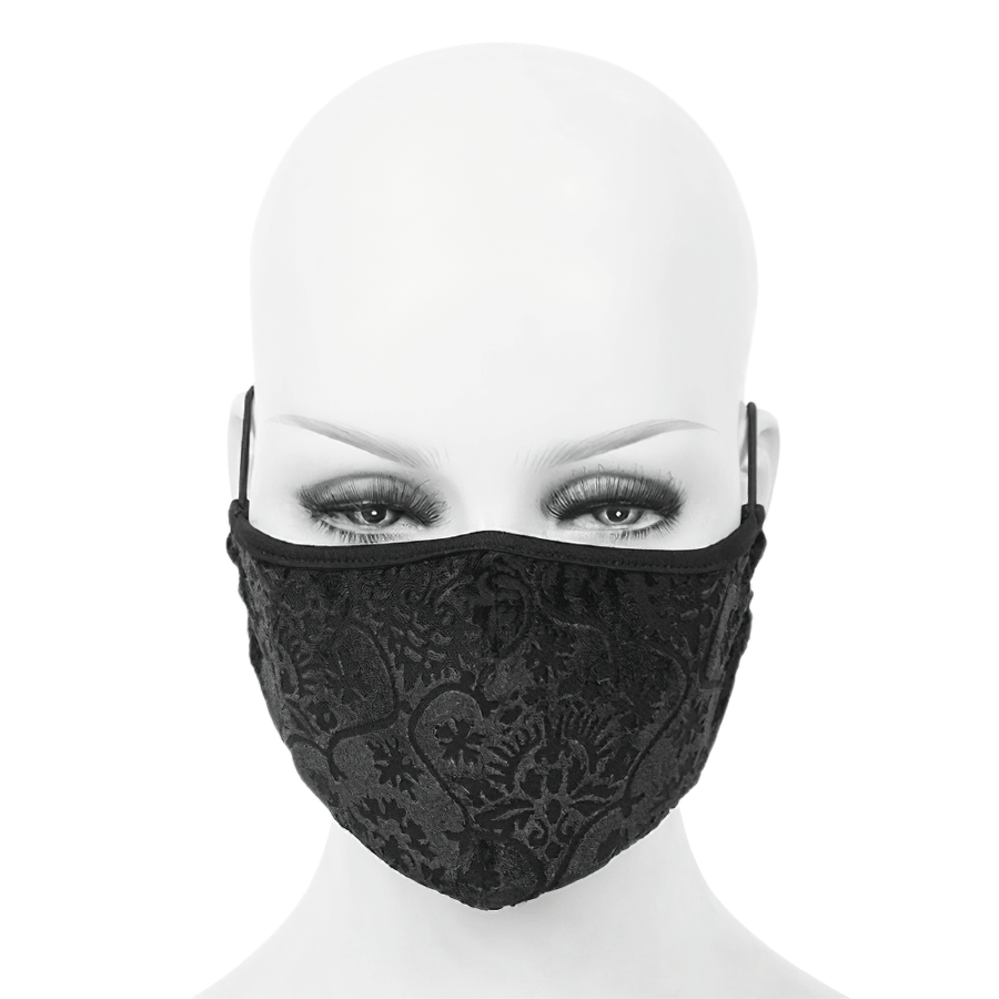 Elegant black gothic mask with baroque patterns worn by a mannequin, featuring adjustable elastic cord.