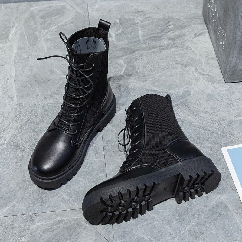 Stylish black lace-up ankle boots with a flexible sole, perfect for casual women's footwear.