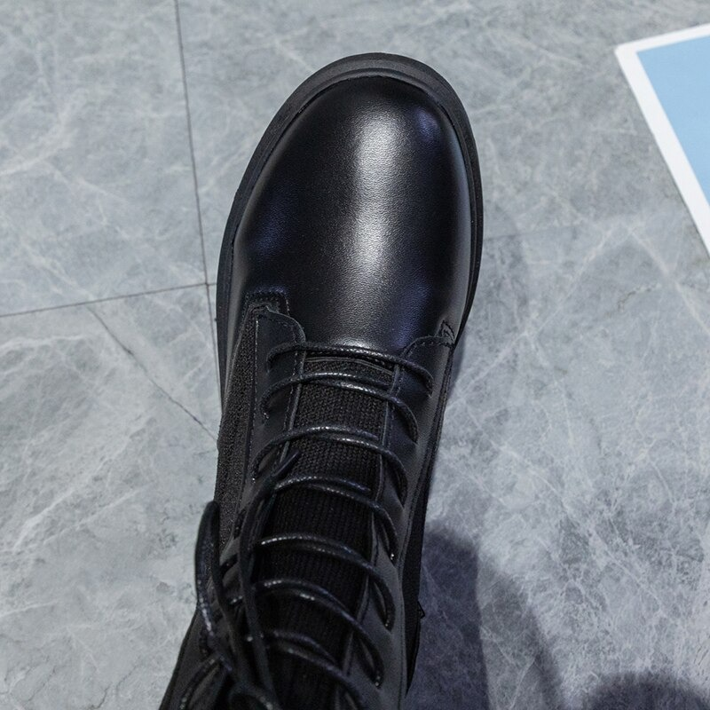 Top view of stylish black lace-up ankle boots with a sleek round toe, perfect for casual wear.