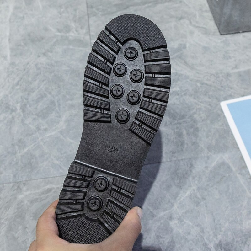 Close-up of a black rubber shoe sole showcasing traction design for comfort and stability.