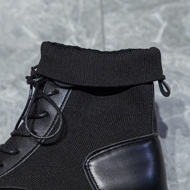 Close-up of warm lace-up ankle boots featuring a cozy black knit cuff and flexible sole for all-day comfort.