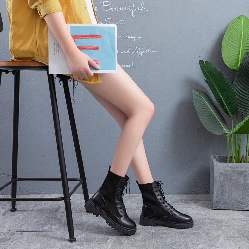 Woman wearing warm lace-up ankle boots with casual outfit, showcasing stylish round toe platform shoes.
