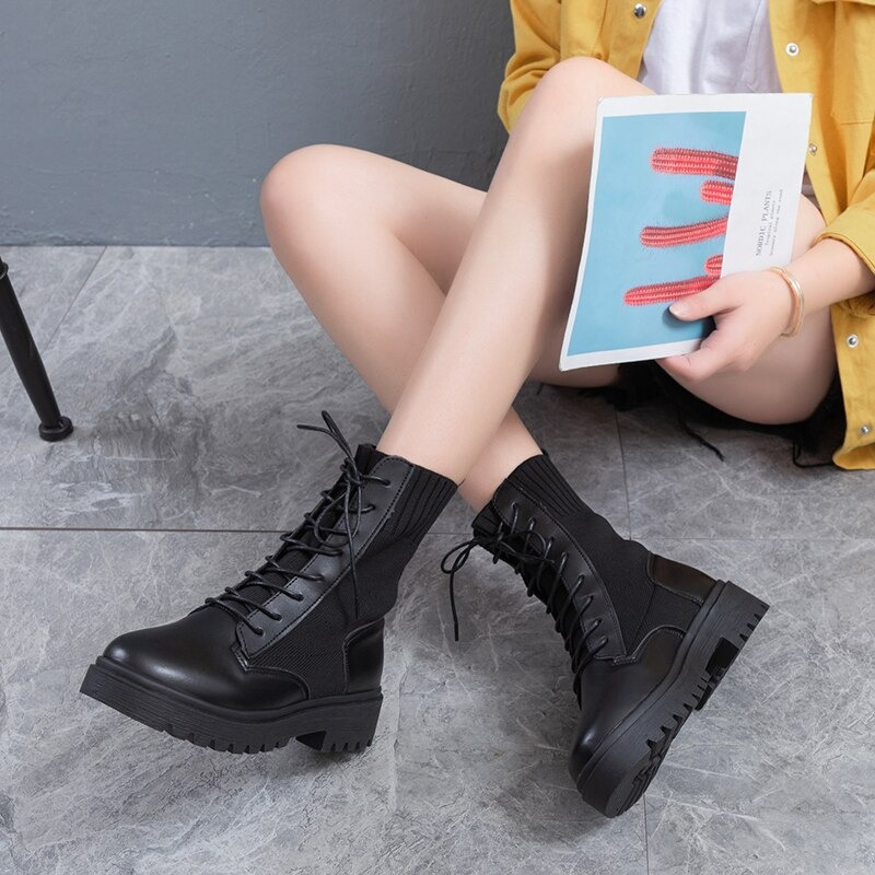 Stylish women's black lace-up ankle boots with a flexible sole, perfect for casual wear and daily comfort.