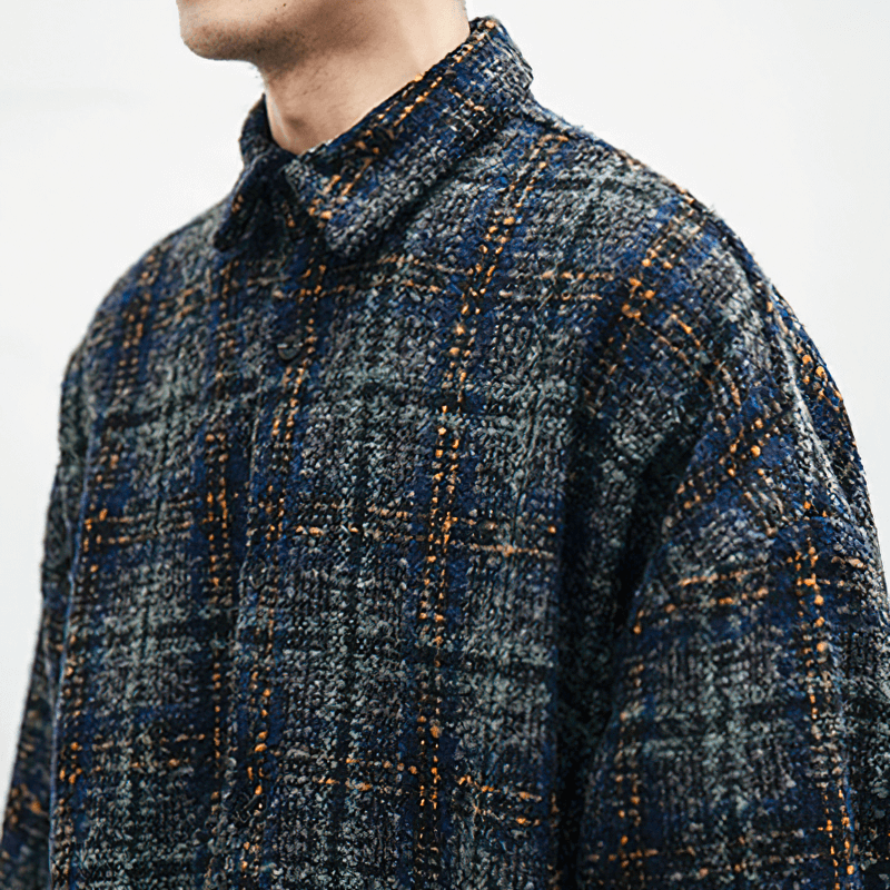 Stylish men’s thick woolen plaid shirt in navy and gray with long sleeves and a casual cut.