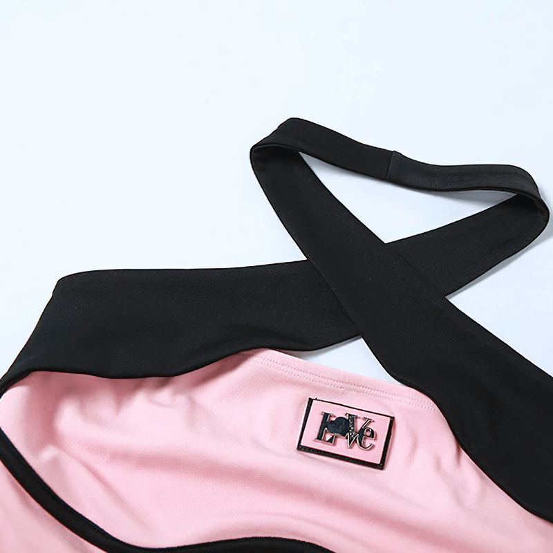 Close-up of a pink and black contrast color halter top showcasing its stylish design and modern cut.