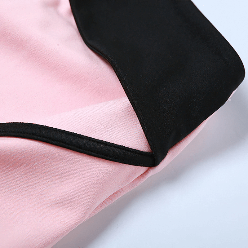 Close-up of women's contrast color halter top in pink and black, showcasing soft fabric and stylish design.