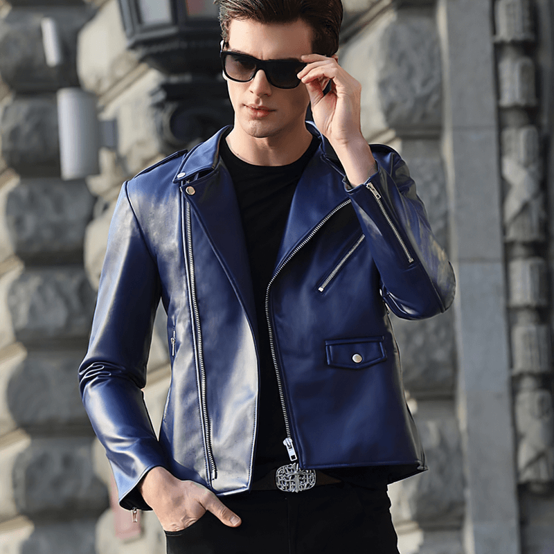 Stylish man wearing a blue faux leather biker jacket, sunglasses on, showcasing a trendy urban look.