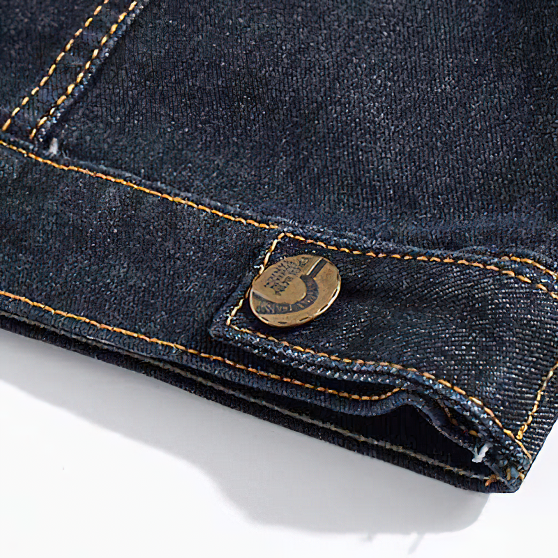 Close-up of a denim vest showing the button detail and contrasting stitching for a cool rock aesthetic.