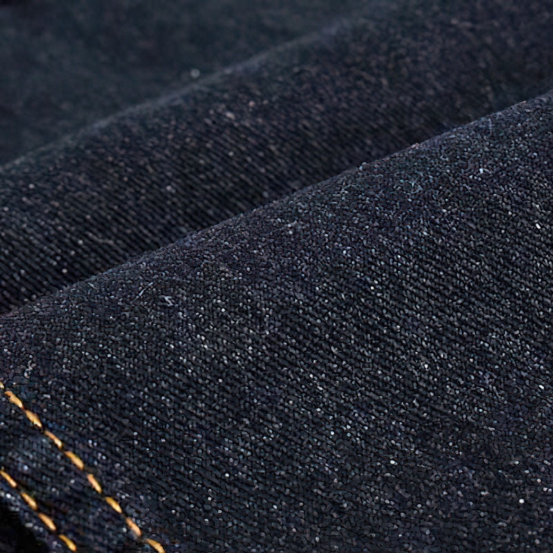 Close-up of dark denim fabric, showcasing texture and stitching, perfect for a stylish denim vest.