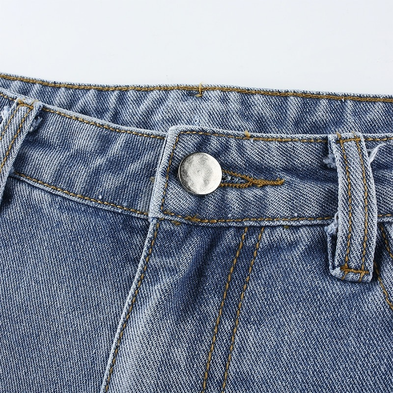 Close-up of high waist denim jeans featuring a silver button and textured fabric for casual style.